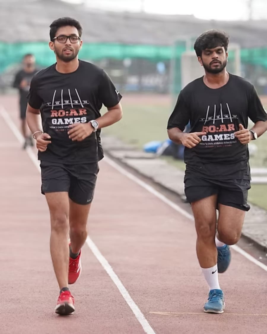 Two men running together on the track