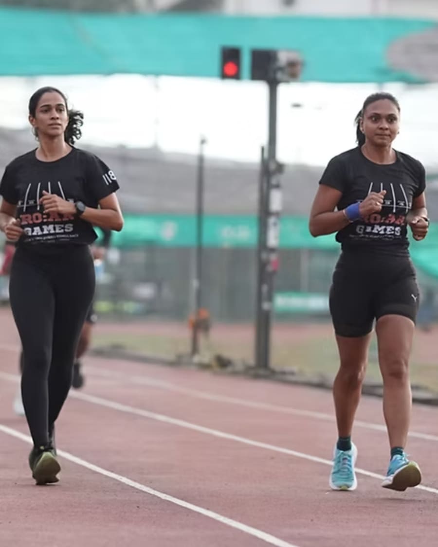 Two women running together on the track