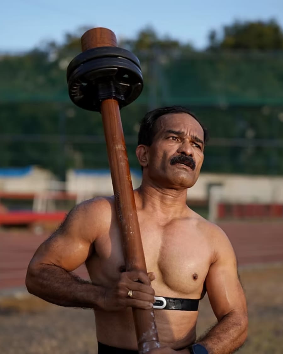Athlete lifting the R.O.A.R mace overhead on the track