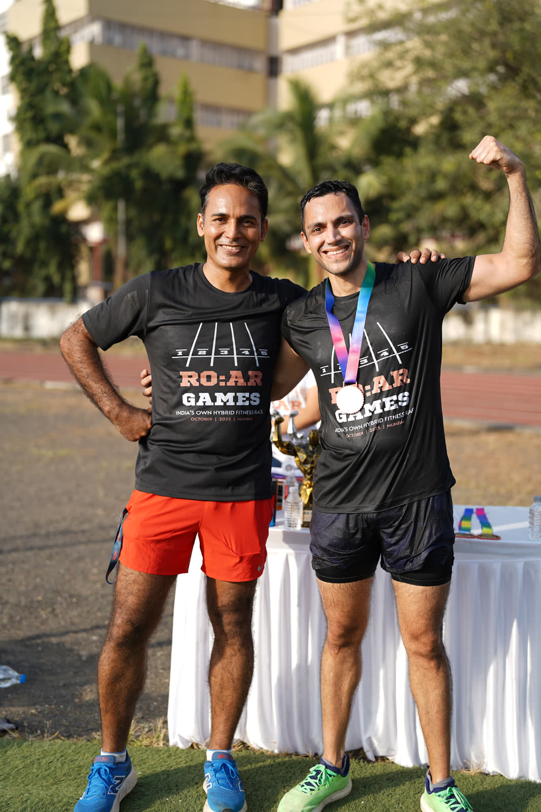 Two finishers celebrating with a R.O.A.R Games medal