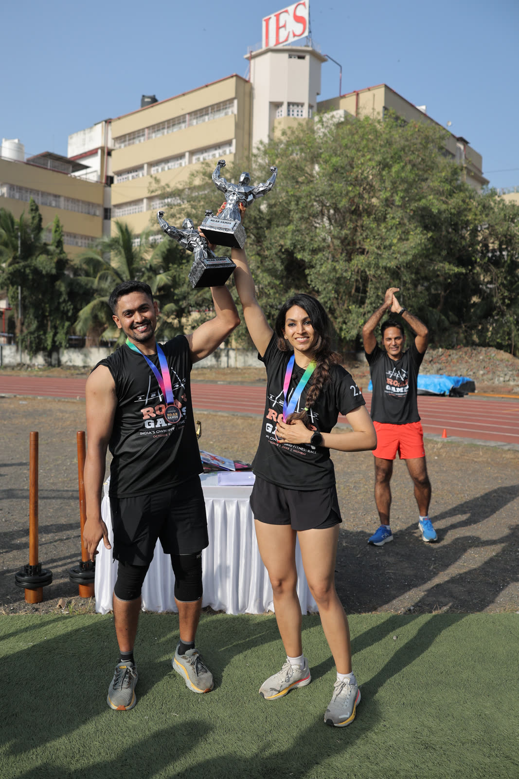Two finishers raising their R.O.A.R Games trophy together