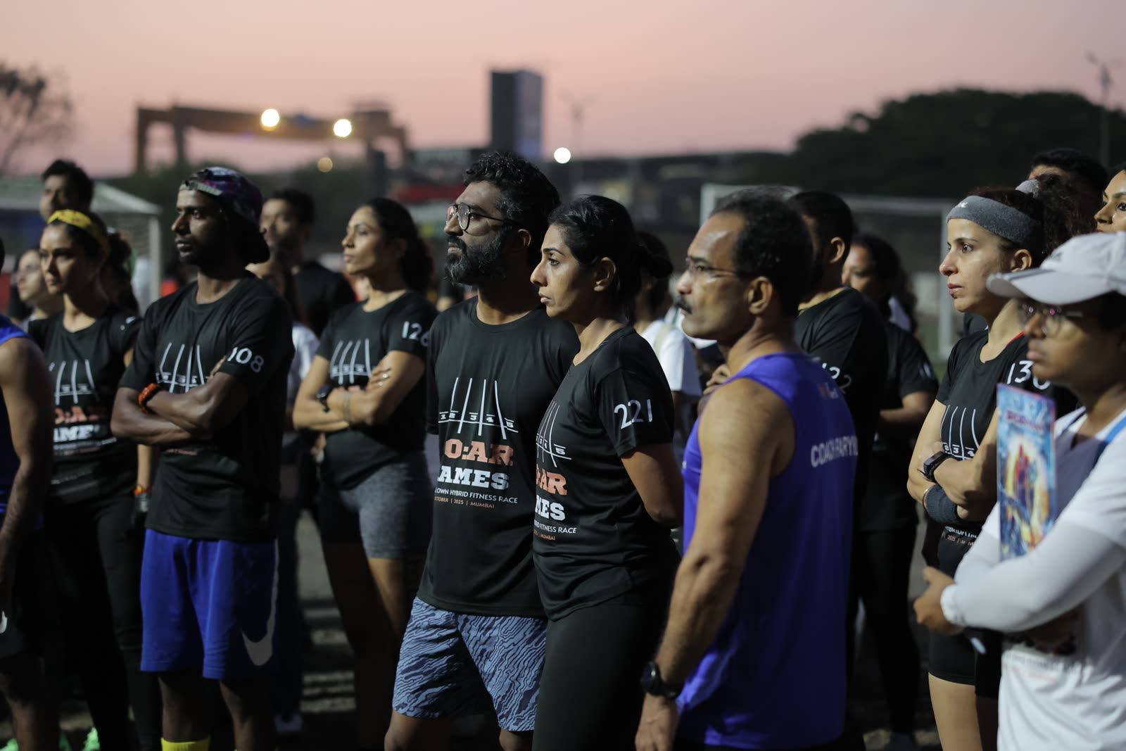Athletes standing together at dusk before the race