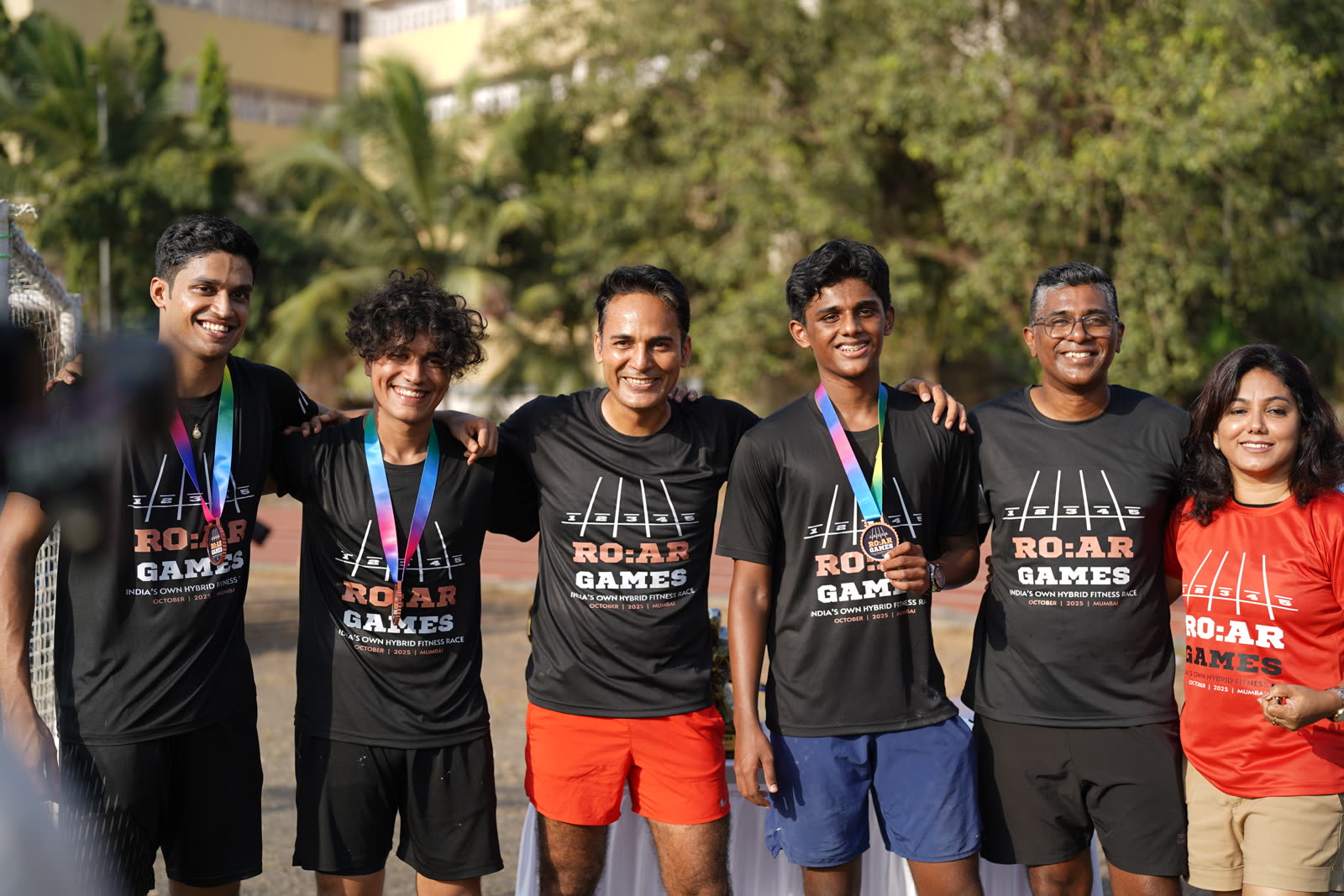 A group of finishers posing together with their medals