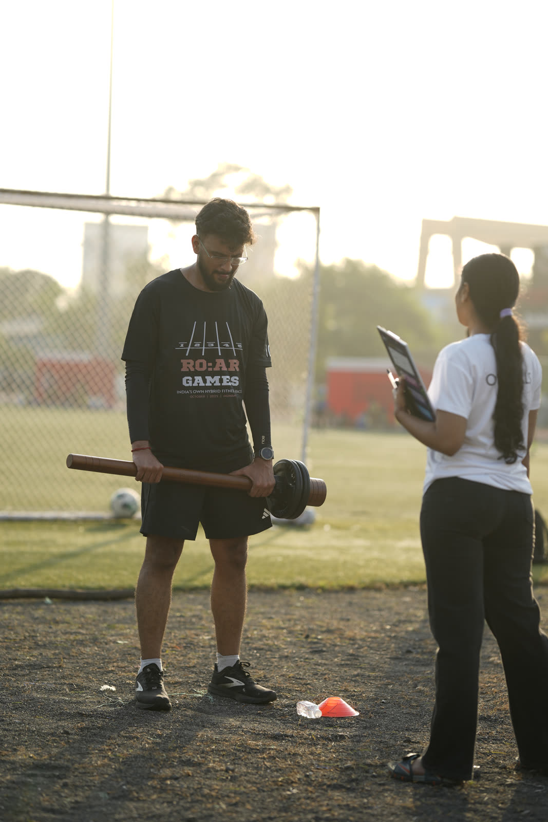 An athlete being briefed while holding the R.O.A.R mace