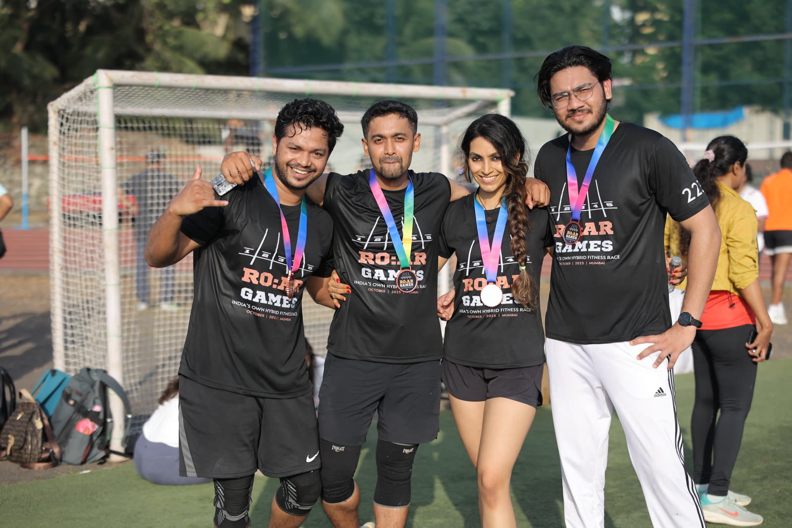 Four finishers posing together with their medals