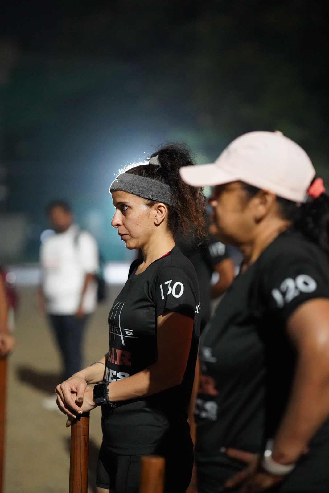 An athlete focused at the start line before a night session