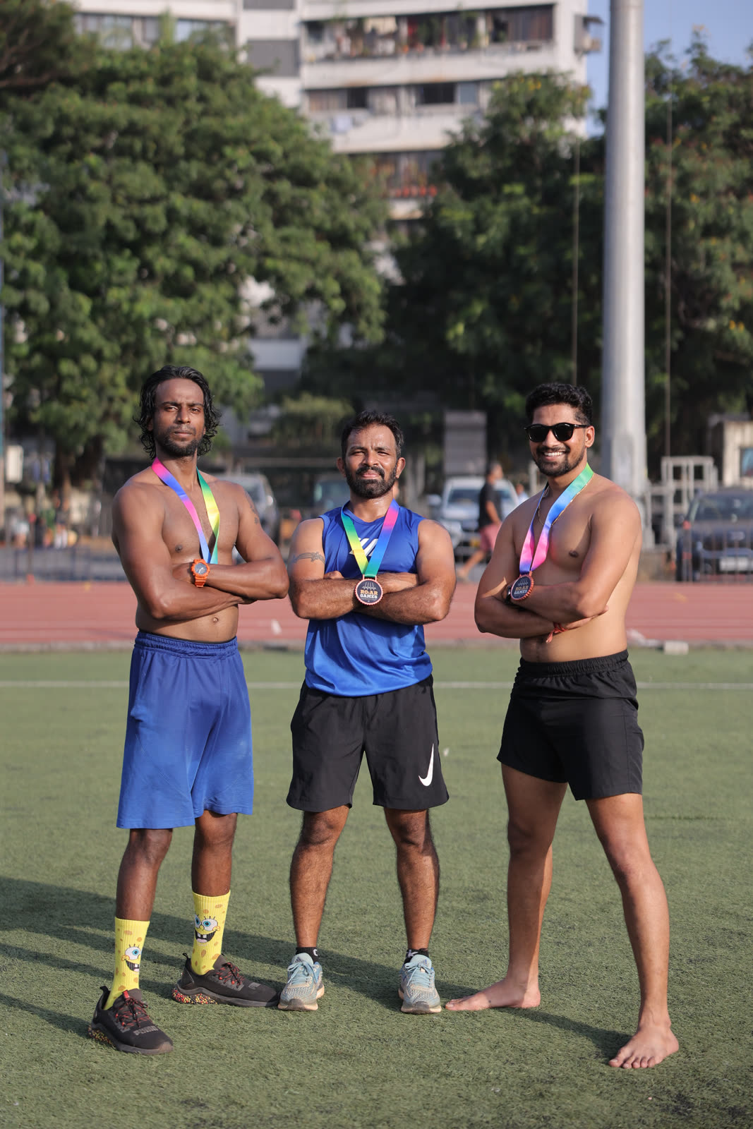 Three finishers posing with their medals