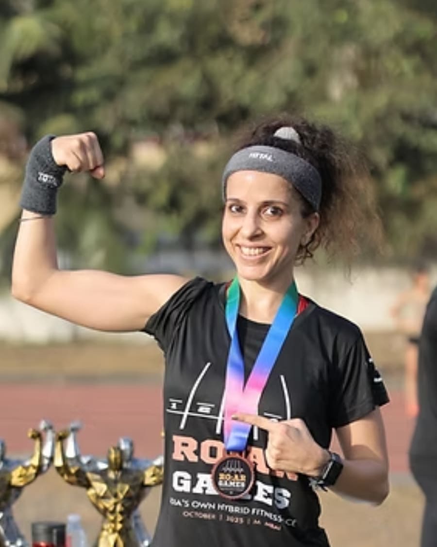 A winner celebrating with her R.O.A.R Games medal and trophies