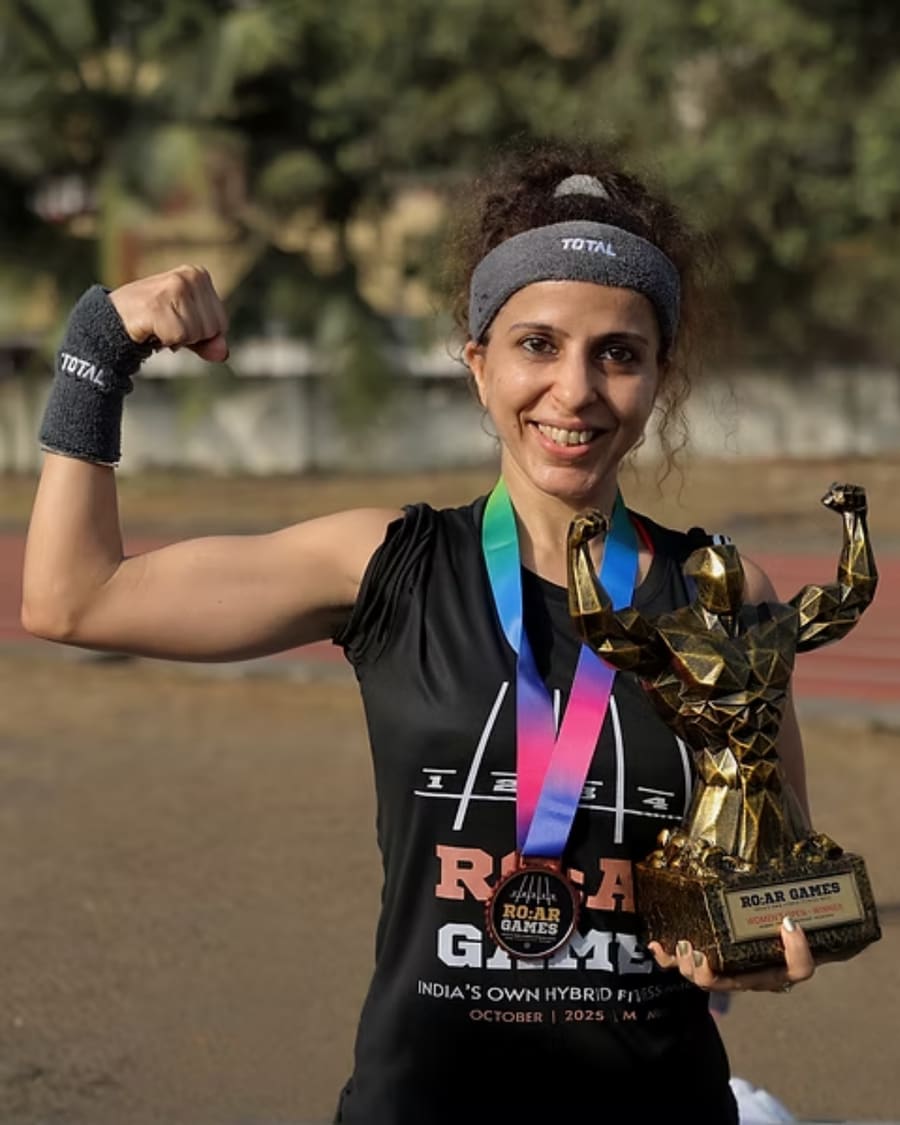 A winner flexing with her R.O.A.R Games trophy